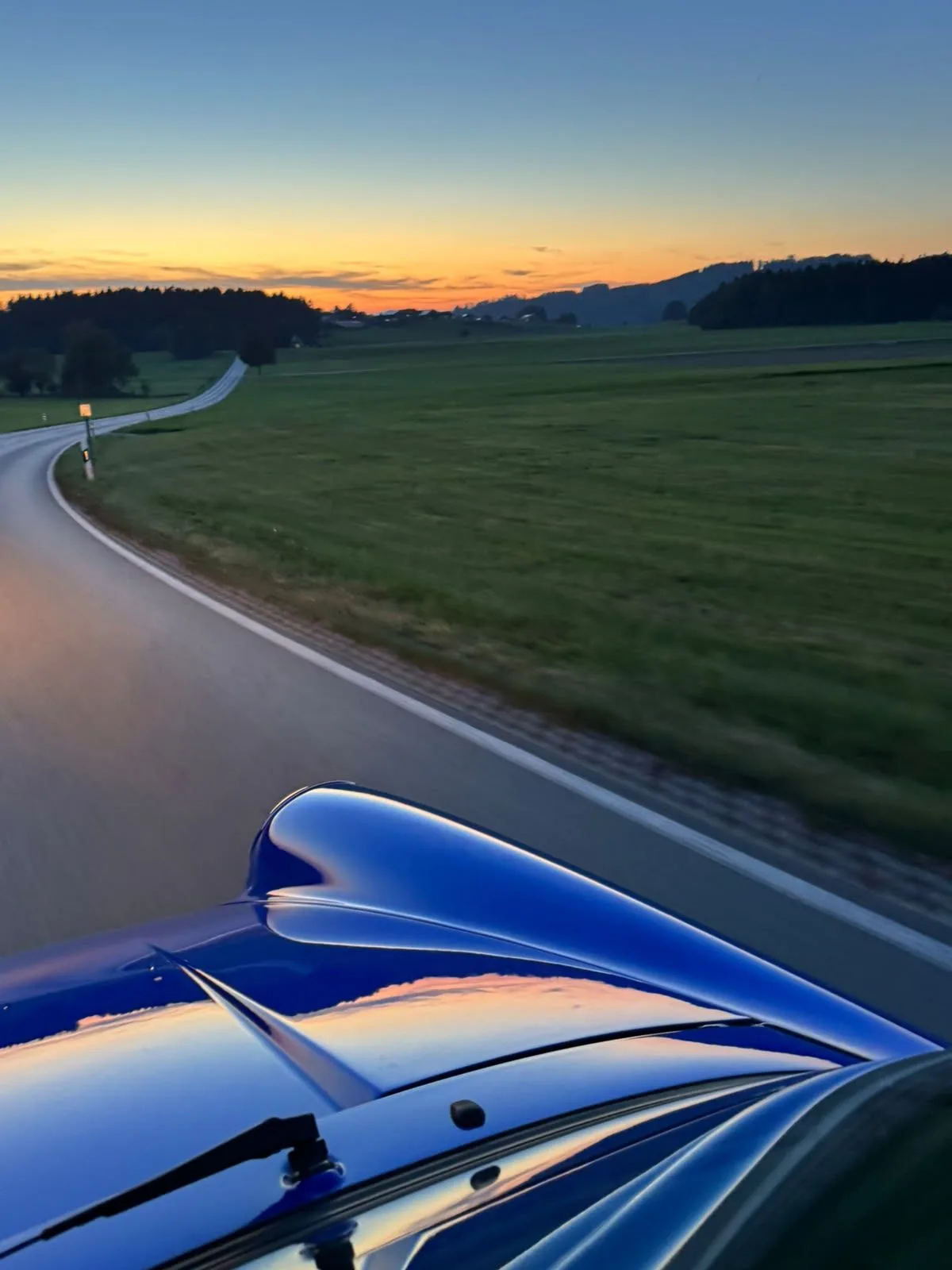 Driving into the sunset, seen over the blue front lid